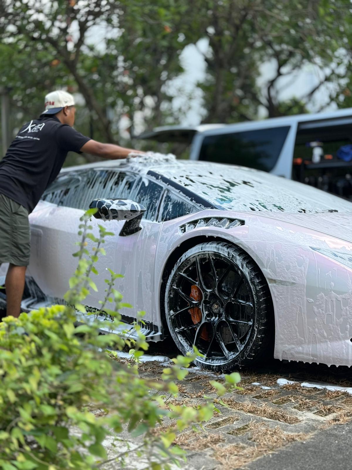 KAA mobile car wash team cleaning a car at a condominium carpark in Singapore